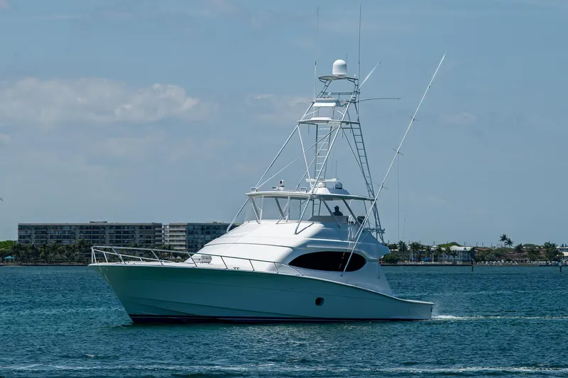 New Paint- 100hrs Yacht Photos Pics 2006 Hatteras 68 Convertible yacht cruising on calm waters.