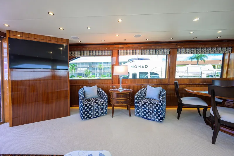 Sapphire Yacht Photos Pics Luxurious interior of 2009 Hatteras Enclosed Bridge yacht with elegant seating and large windows.