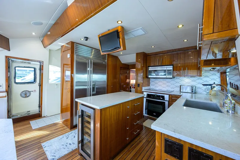 Sapphire Yacht Photos Pics Luxurious 2009 Hatteras Enclosed Bridge yacht kitchen with modern appliances and elegant wood finishes.