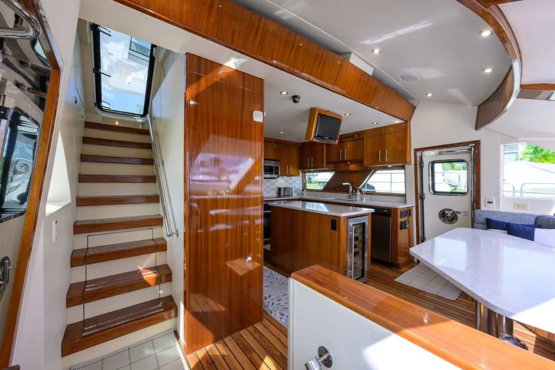 Sapphire Yacht Photos Pics Luxurious 2009 Hatteras Enclosed Bridge yacht interior with modern kitchen and elegant wood finishes.