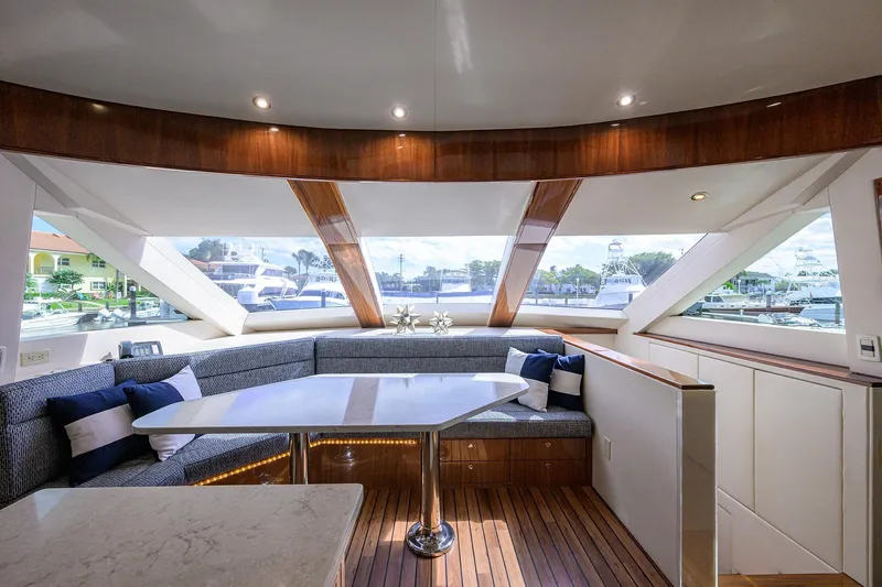 Sapphire Yacht Photos Pics Luxurious interior of 2009 Hatteras Enclosed Bridge yacht with panoramic windows and elegant seating.