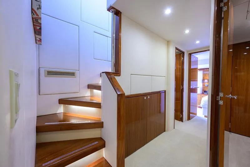 Sapphire Yacht Photos Pics Interior of 2009 Hatteras Enclosed Bridge yacht with wooden stairs and modern lighting.