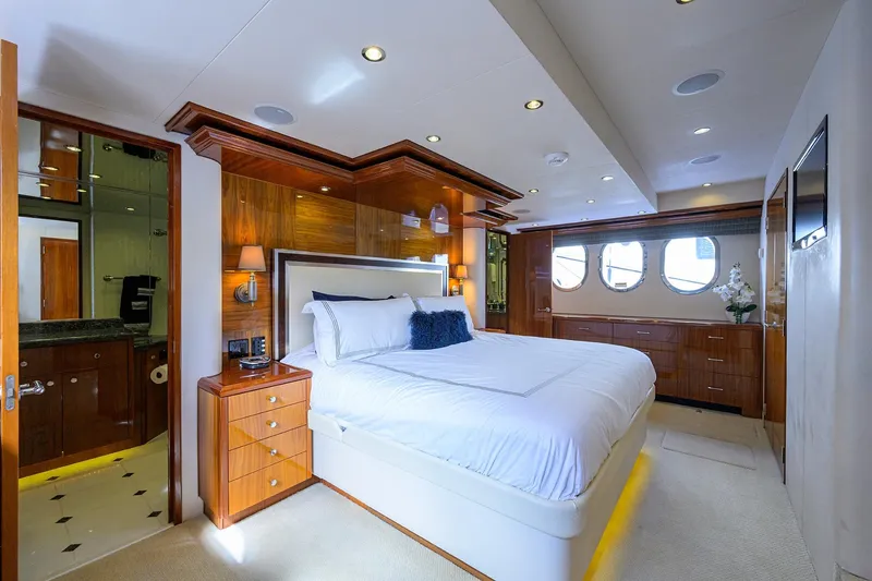 Sapphire Yacht Photos Pics Luxurious bedroom interior on 2009 Hatteras Enclosed Bridge yacht, featuring elegant wood finishes.