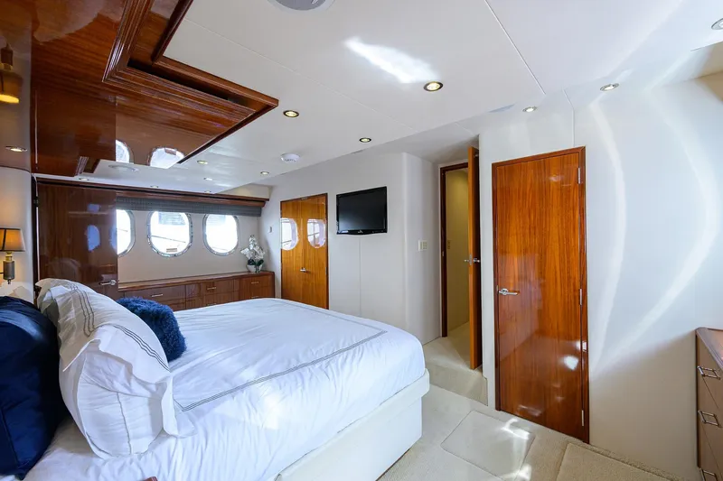 Sapphire Yacht Photos Pics Luxurious bedroom interior on 2009 Hatteras Enclosed Bridge yacht with elegant wood finishes.