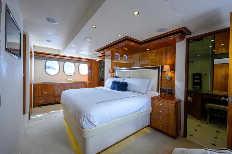 Sapphire Yacht Photos Pics Luxurious bedroom interior on 2009 Hatteras Enclosed Bridge yacht, featuring elegant wood finishes.