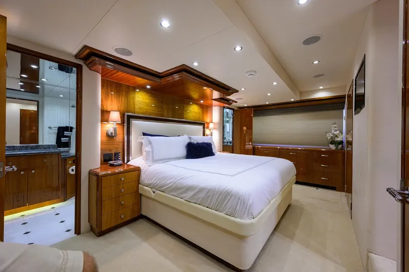 Sapphire Yacht Photos Pics Luxurious bedroom interior on 2009 Hatteras Enclosed Bridge yacht, featuring elegant wood finishes.