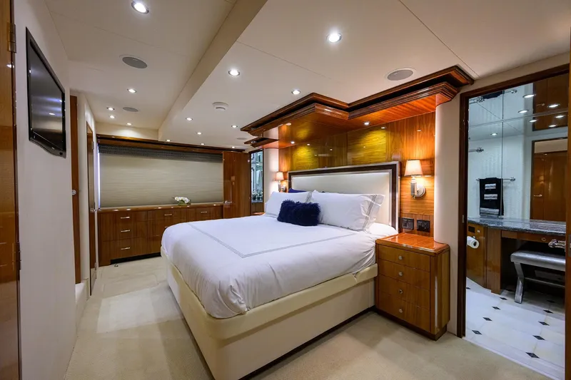 Sapphire Yacht Photos Pics Luxurious bedroom interior of 2009 Hatteras Enclosed Bridge yacht with elegant wood finishes.
