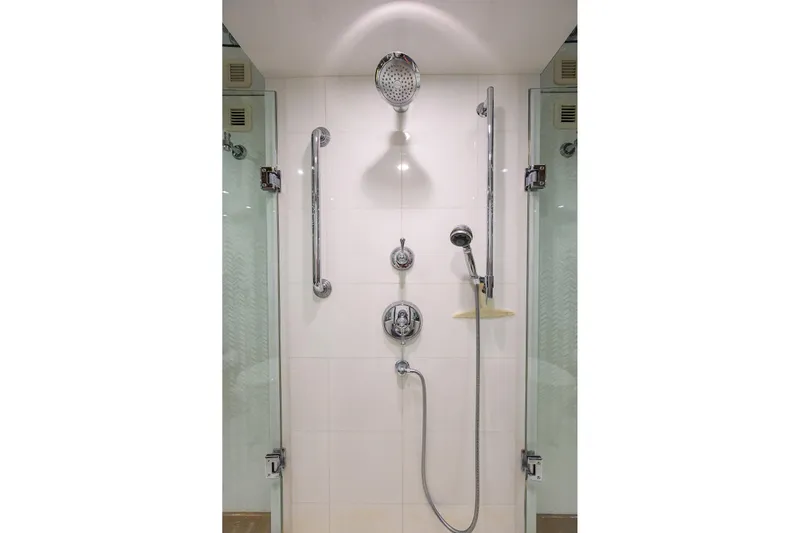 Sapphire Yacht Photos Pics Luxury shower in 2009 Hatteras Enclosed Bridge yacht, featuring modern fixtures and glass doors.