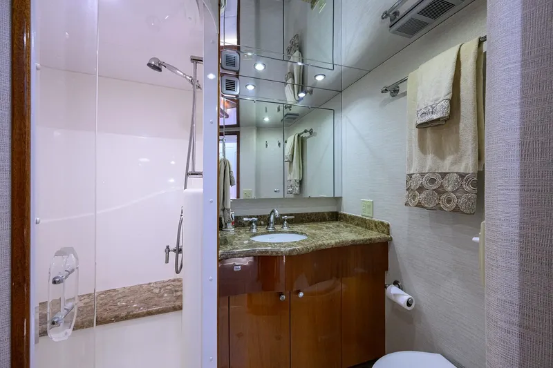 Sapphire Yacht Photos Pics Luxurious bathroom in 2009 Hatteras Enclosed Bridge yacht with marble countertop and glass shower.