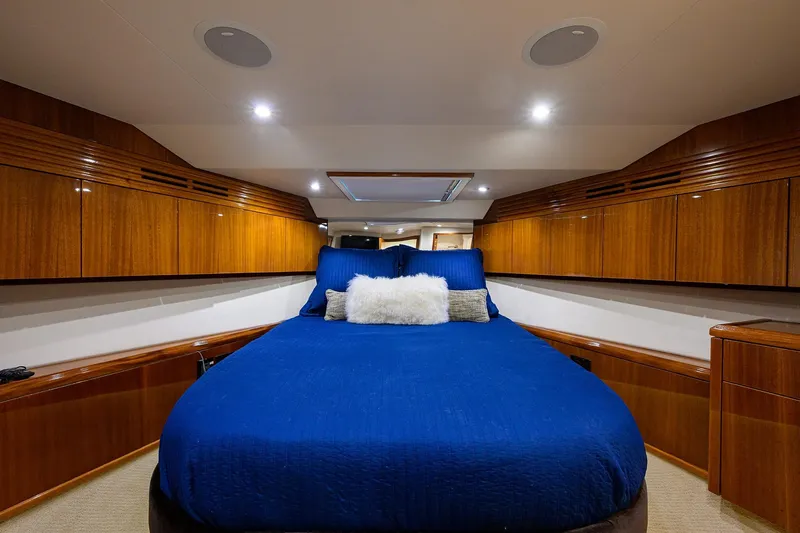 Sapphire Yacht Photos Pics Luxurious cabin interior of 2009 Hatteras Enclosed Bridge yacht with blue bedding.