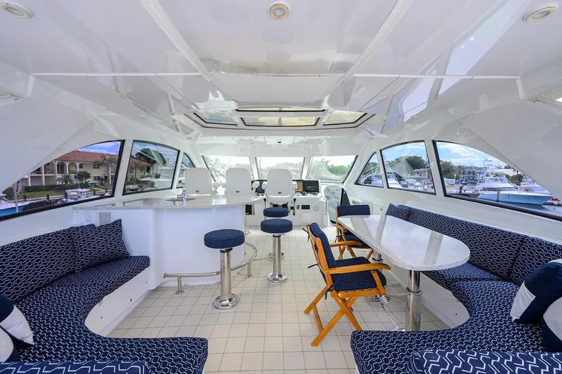 Sapphire Yacht Photos Pics Luxurious 2009 Hatteras Enclosed Bridge yacht interior with elegant seating and panoramic windows.