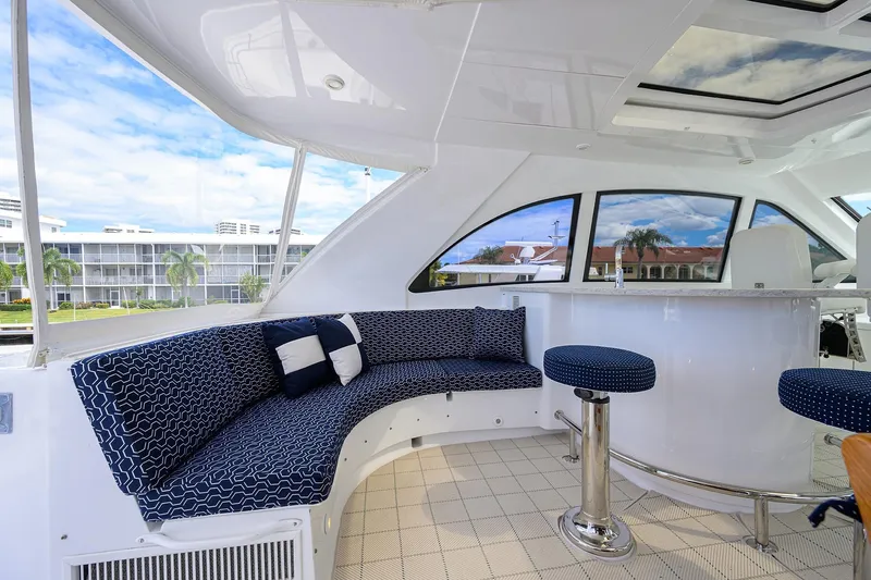 Sapphire Yacht Photos Pics Luxurious 2009 Hatteras Enclosed Bridge yacht interior with plush seating and panoramic windows.