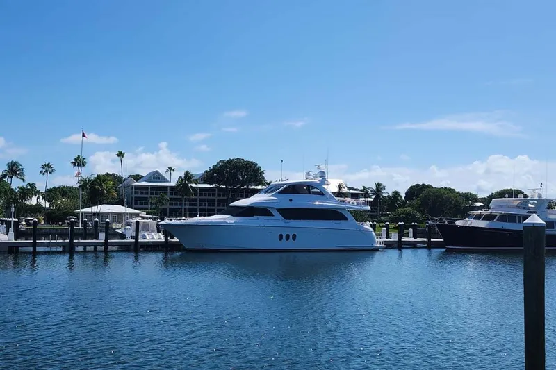 Sapphire Yacht Photos Pics 2009 Hatteras Enclosed Bridge yacht docked in a sunny marina setting.