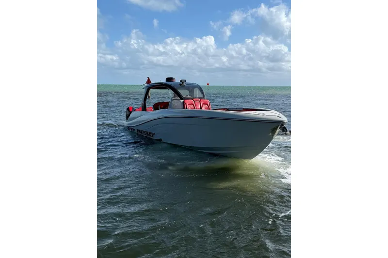 Yacht Photos Pics 2020 Deep Impact 399 Sport boat on water, featuring sleek design and red seating.