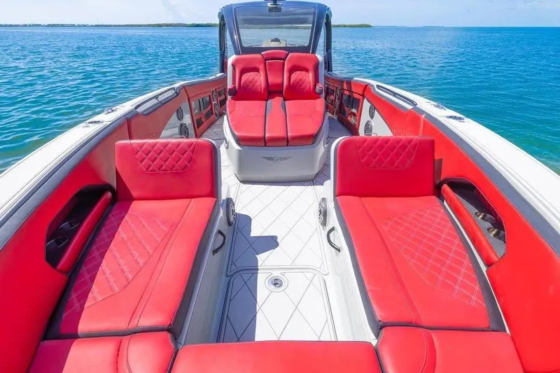 Yacht Photos Pics Luxurious 2020 Deep Impact 399 Sport boat with vibrant red seating on open water.