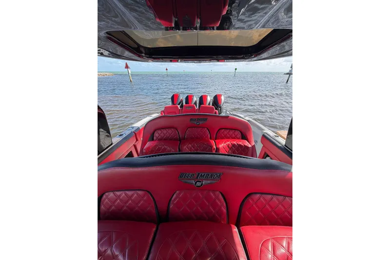  Yacht Photos Pics 2020 Deep Impact 399 Sport boat with luxurious red interior on open water.