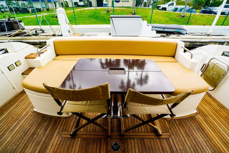  Yacht Photos Pics Luxurious 2012 Azimut Fly 53 yacht deck with seating and table, featuring elegant wood finish.