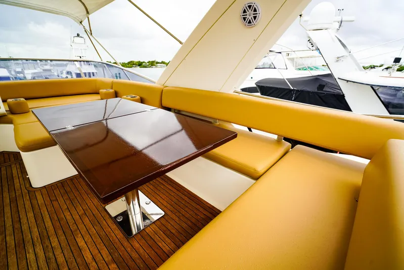  Yacht Photos Pics Luxurious seating area on 2012 Azimut Fly 53 yacht with wooden table and cushioned benches.