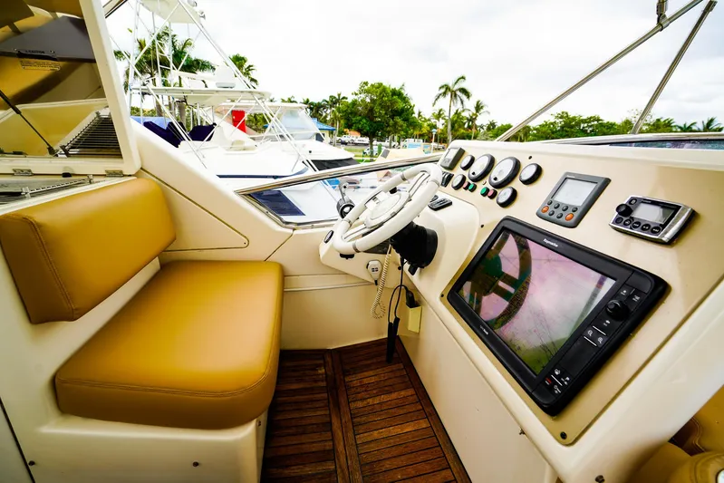  Yacht Photos Pics Helm of 2012 Azimut Fly 53 yacht with modern controls and tan seating.