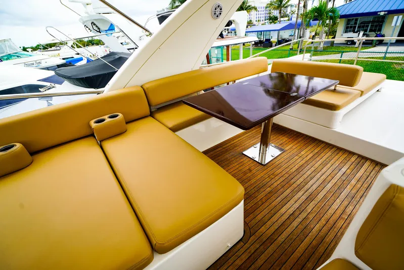  Yacht Photos Pics Luxurious seating area on 2012 Azimut Fly 53 yacht with wooden deck and table.