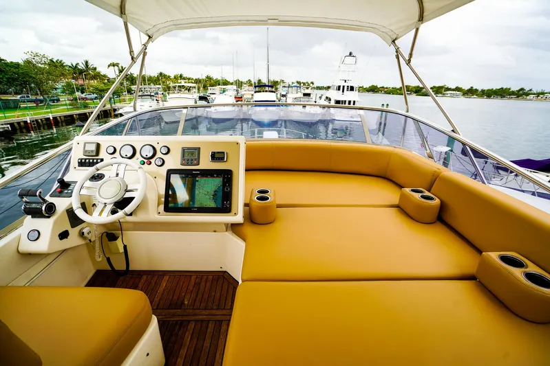  Yacht Photos Pics Luxurious 2012 Azimut Fly 53 yacht helm with tan seating and modern navigation controls.