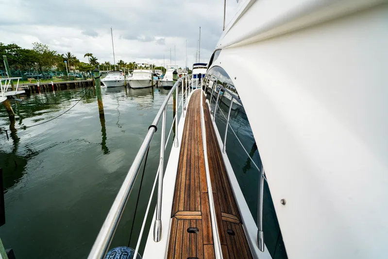  Yacht Photos Pics 2012 Azimut Fly 53 yacht docked at marina, featuring sleek design and wooden deck.