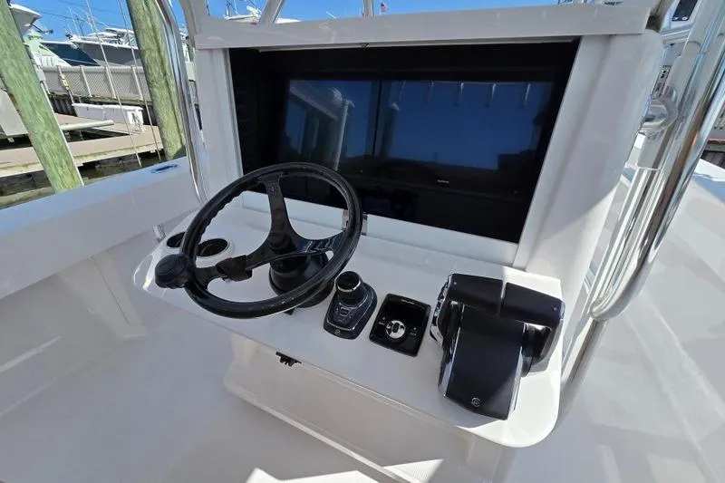  Yacht Photos Pics 2025 Bahama 35 boat helm with steering wheel and control panel.