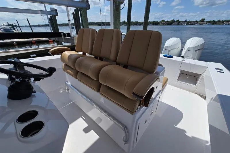 Yacht Photos Pics 2025 Bahama 35 boat interior with tan seating and dual outboard motors.
