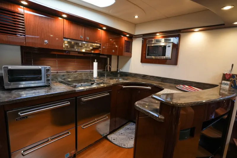 Victoria Yacht Photos Pics Luxurious kitchen interior of 2013 Sea Ray 610 Sundancer yacht with modern appliances.