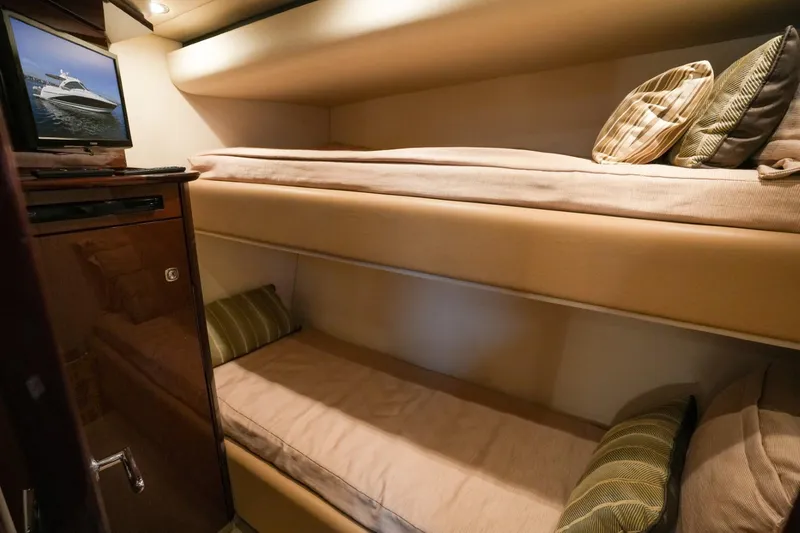 Victoria Yacht Photos Pics 2013 Sea Ray 610 Sundancer cabin with cozy bunk beds and a small TV.