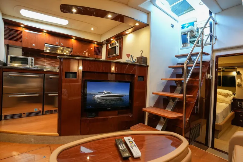 Victoria Yacht Photos Pics Luxurious interior of 2013 Sea Ray 610 Sundancer yacht with modern kitchen and entertainment area.