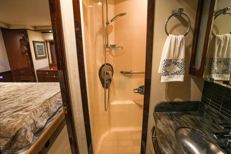 Victoria Yacht Photos Pics Luxurious bathroom in 2013 Sea Ray 610 Sundancer yacht, featuring shower and elegant sink area.