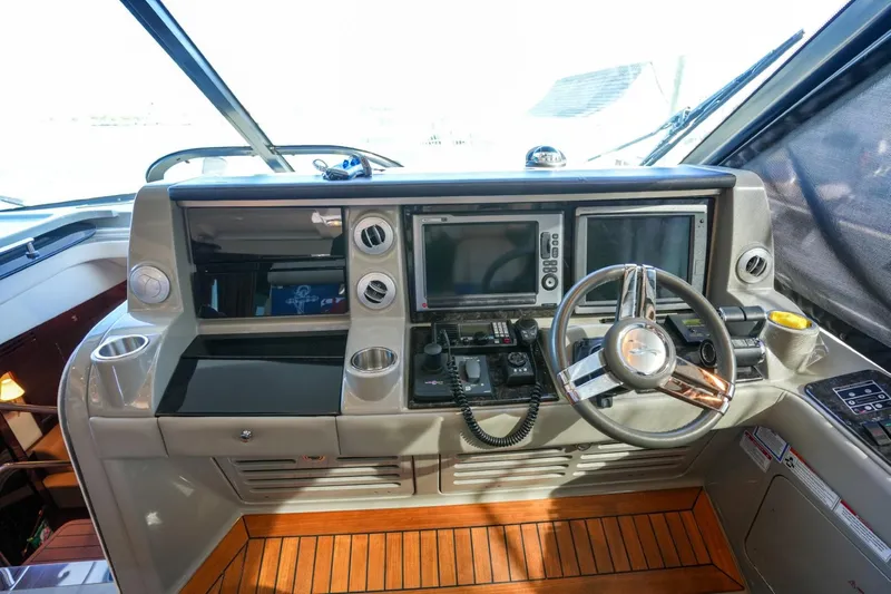 Victoria Yacht Photos Pics Helm of 2013 Sea Ray 610 Sundancer yacht with modern navigation equipment and wooden flooring.