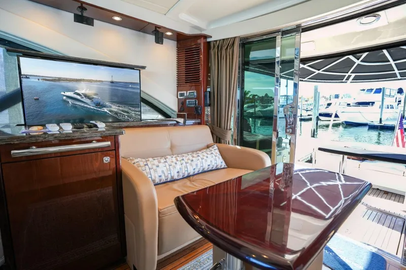 Victoria Yacht Photos Pics Luxurious interior of 2013 Sea Ray 610 Sundancer yacht with elegant seating and marina view.