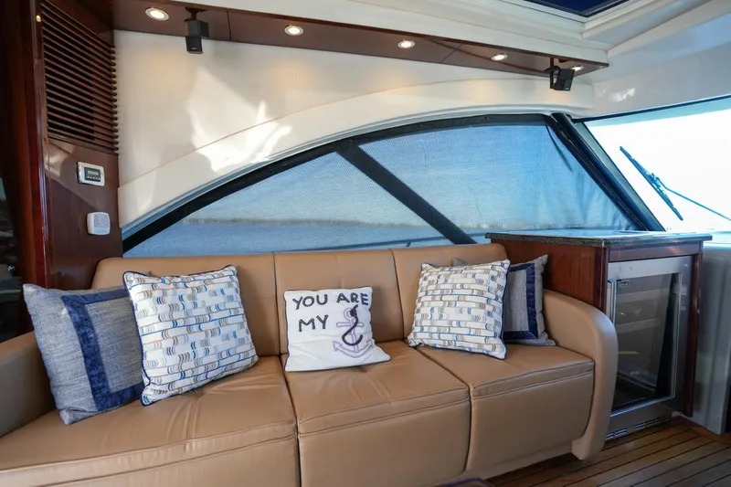 Victoria Yacht Photos Pics Luxurious interior of 2013 Sea Ray 610 Sundancer with plush seating and decorative pillows.