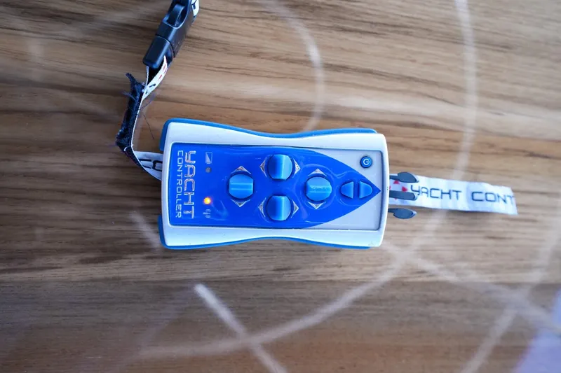 Victoria Yacht Photos Pics Remote control for 2013 Sea Ray 610 Sundancer yacht on wooden surface.