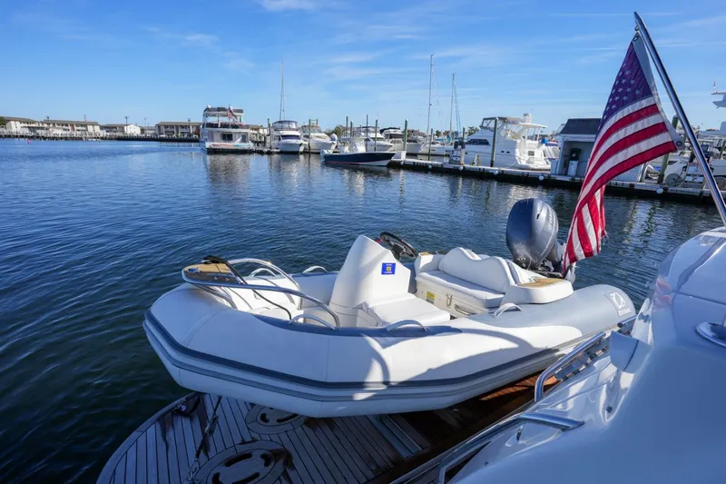 Victoria Yacht Photos Pics 2013 Sea Ray 610 Sundancer yacht with dinghy and American flag at marina.