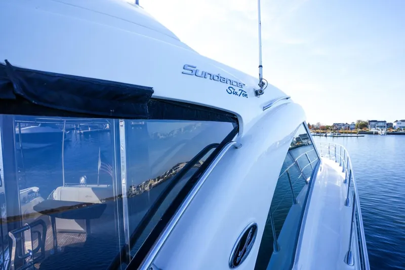 Victoria Yacht Photos Pics 2013 Sea Ray 610 Sundancer yacht on calm water, showcasing sleek design and luxury features.