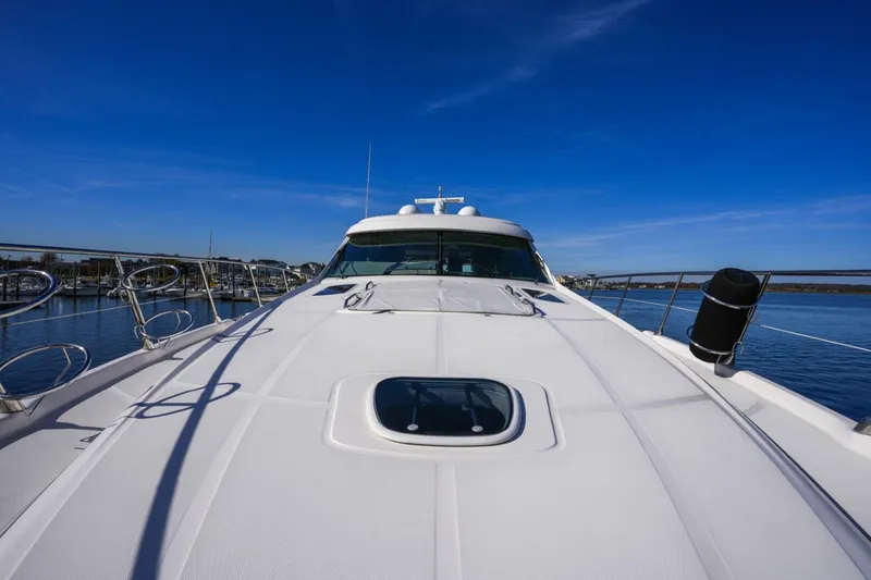 Victoria Yacht Photos Pics 2013 Sea Ray 610 Sundancer yacht on calm water under clear blue sky.