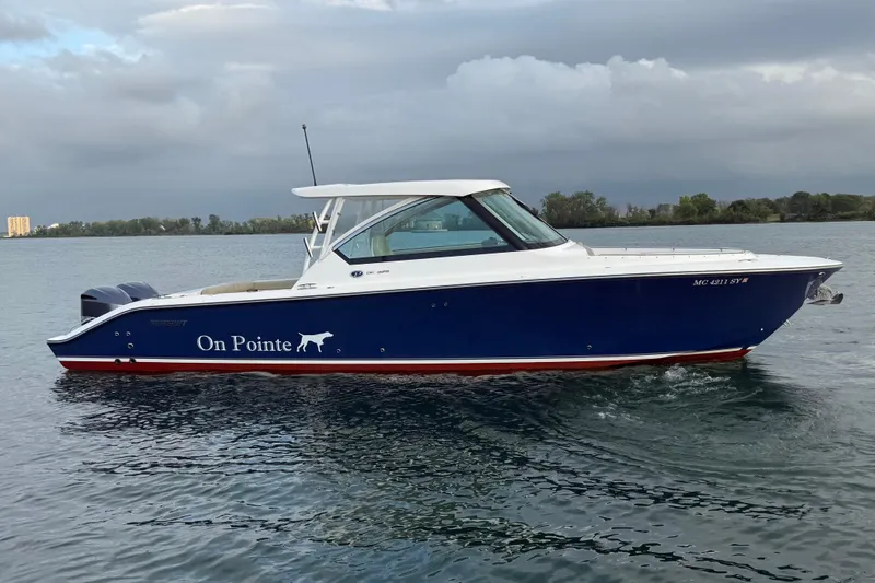 On Pointe Yacht Photos Pics 2016 Pursuit DC 325 Dual Console boat named "On Pointe" on calm water.