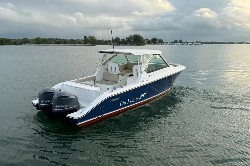 On Pointe Yacht Photos Pics 2016 Pursuit DC 325 Dual Console boat on calm water with Yamaha engines.