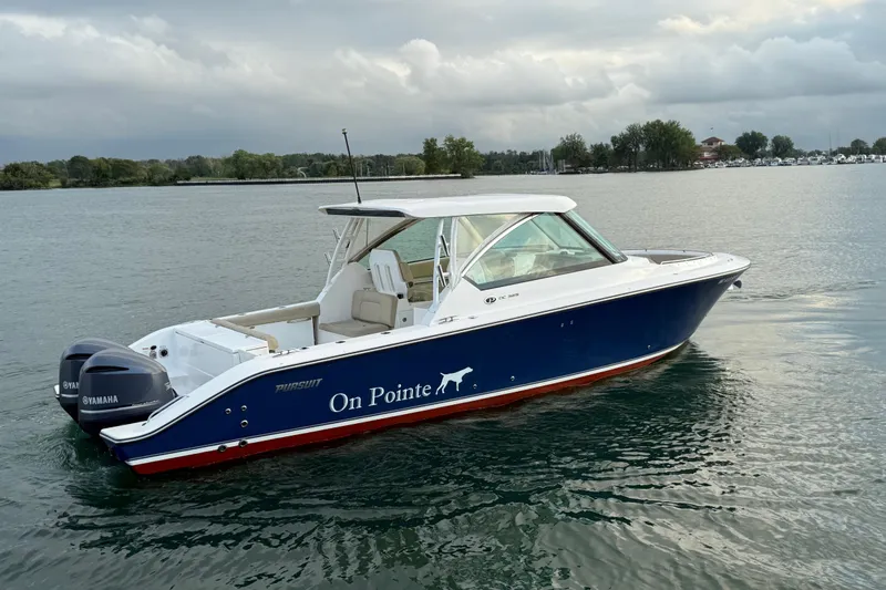 On Pointe Yacht Photos Pics 2016 Pursuit DC 325 Dual Console boat on calm water, overcast sky.