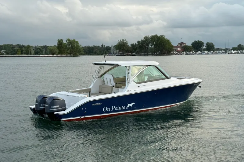 On Pointe Yacht Photos Pics 2016 Pursuit DC 325 Dual Console boat on calm water, overcast sky.