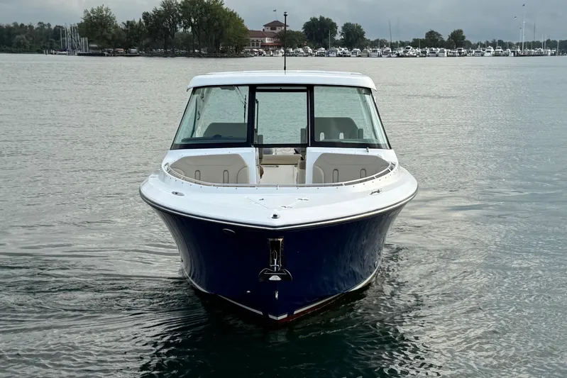 On Pointe Yacht Photos Pics 2016 Pursuit DC 325 Dual Console boat on calm water, front view.