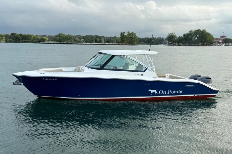 On Pointe Yacht Photos Pics 2016 Pursuit DC 325 Dual Console boat named "On Pointe" on calm water.