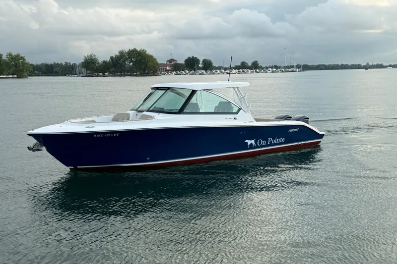 On Pointe Yacht Photos Pics 2016 Pursuit DC 325 Dual Console boat on calm water, overcast sky.