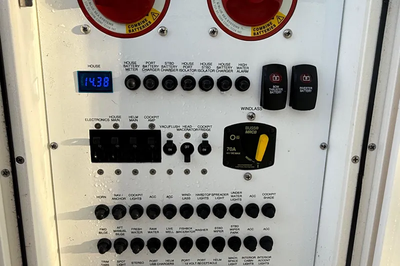On Pointe Yacht Photos Pics Control panel of a 2016 Pursuit DC 325 Dual Console boat, showing various switches and indicators.