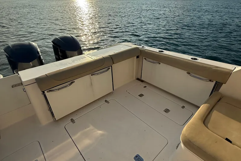 On Pointe Yacht Photos Pics 2016 Pursuit DC 325 Dual Console boat interior with twin engines on calm water.