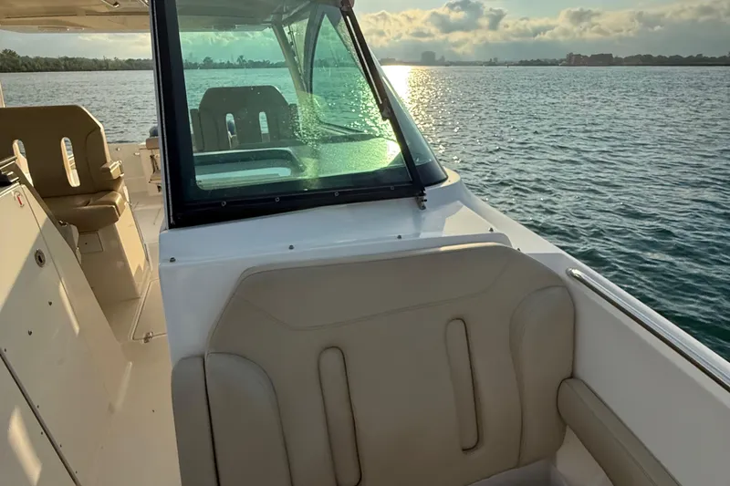 On Pointe Yacht Photos Pics 2016 Pursuit DC 325 Dual Console boat on water at sunset.