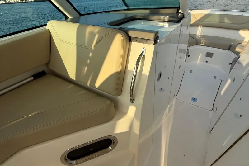 On Pointe Yacht Photos Pics 2016 Pursuit DC 325 Dual Console interior with beige seating and sleek design.